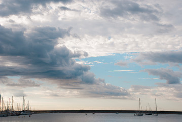 Beautiful sky with clouds and sea with yachts.