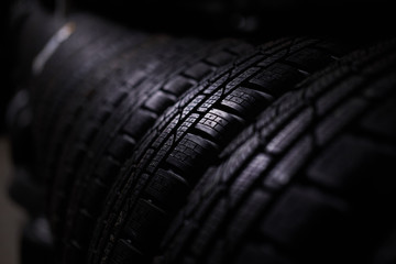 Closeup photo shoot of new unused car's tyres with bold specific texture.