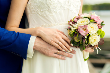 Obraz na płótnie Canvas the groom gently holds the bride's hands