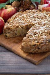 fresh apple pie in a cut on wooden board, vertical