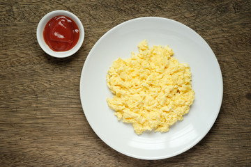 Scramble on a white plate with copy space,ketchup bowl