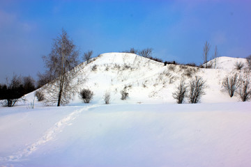 Fototapeta na wymiar Winter: a snowy hill, a walk in nature, on the street