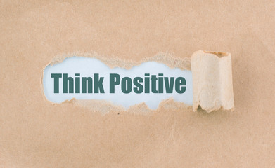 Letter Think Positive Written Behind Torn Paper