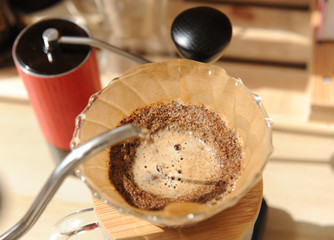 Coffee brewing in glass pour over with paper filter