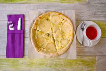 Delicious pizza with Round Pear Slices, Roquefort Blue Cheese served at Italian Restaurant with Plate. Traditional Food