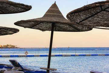 Rest by the sea. Beach umbrellas.