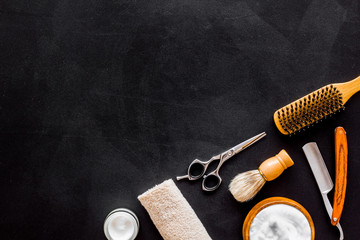 Men's hairdressing tools on black background top view space for text