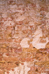 Old brick wall. Gray plaster on the wall. The uneven surface of the walls with drops of paint. Abstract textured vintage background