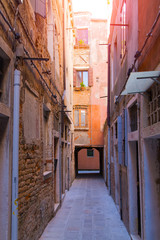 Fototapeta na wymiar Narrow morning sunny street in Venice