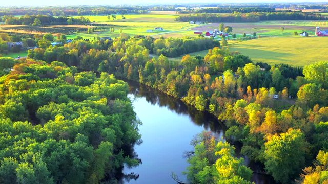 Flying over Autumn colors by the Oconto River, rural Wisconsin, aerial view.