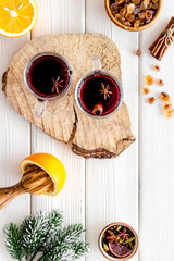 New Year composition with mulled wine and fir branches on white wooden background top view