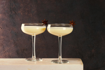 Two glasses of Eggnog decorated with anise stars