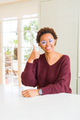 Beautiful young african woman with afro hair wearing glasses