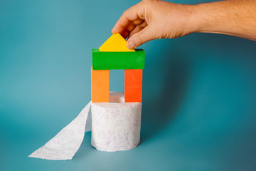 potty training concept. Roll of toilet paper and toys on blue background