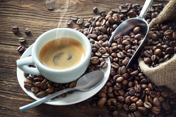 Cup of espresso with coffee beans