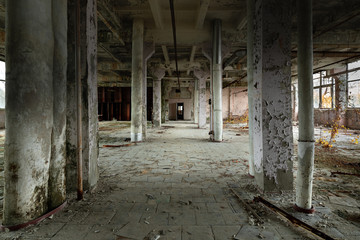 Abandoned industrial interior with large columns