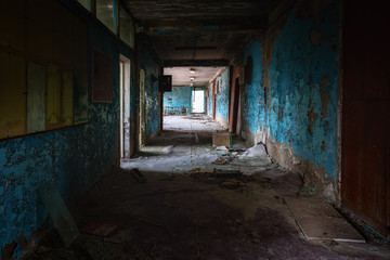 Abandoned corridor in damaged building angle shot