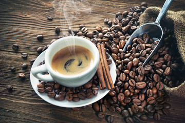 Cup of espresso with coffee beans
