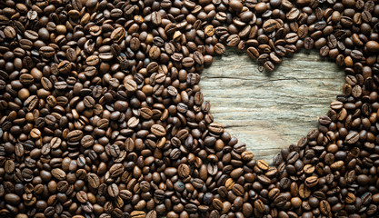 Coffee beans in heart shape on rustic wooden