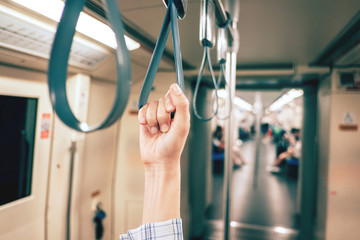 Closeup Hand holding Handle on the train.