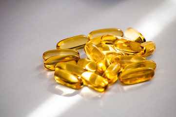 Close up of food supplement oil filled capsules suitable for: fish oil, omega 3, omega 6, omega 9,...