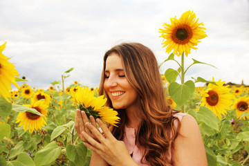 Beautiful woman in a sunflower field