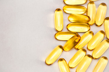 Close up of food supplement oil filled capsules suitable for: fish oil, omega 3, omega 6, omega 9,...
