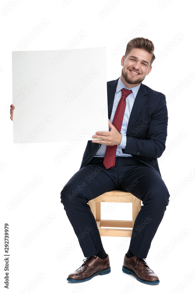 Poster happy young businessman holding empty white board