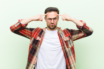 young handsome man with a serious and concentrated look, brainstorming and thinking about a challenging problem