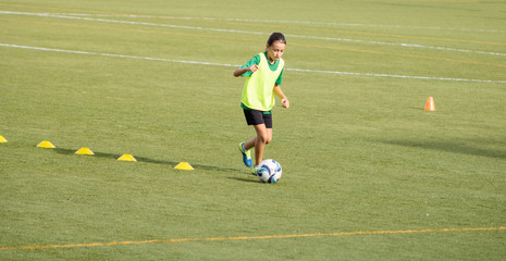 Little girl in a soccer training