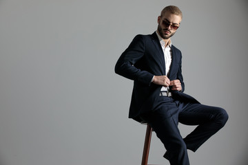 businessman sitting and holding button while looking down © Viorel Sima