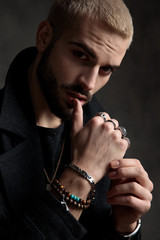 seductive young fashion model wearing longcoat in studio