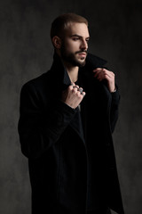 arrogant young model holding collar and looking to side