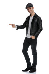 casual man standing and pointing sideways looking ahead