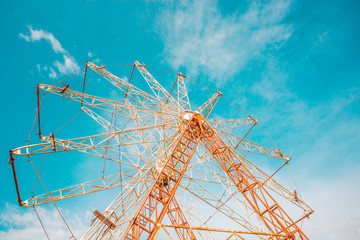 old abandoned Park, empty metal Ferris wheel without cabins in absence of visitors, a day off, repairs and an abandoned creepy place, like Pripyat, disassembled into parts a children's attraction