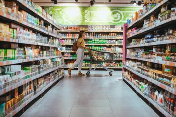 Foto op Plexiglas woman with shopping between store shelf © phpetrunina14