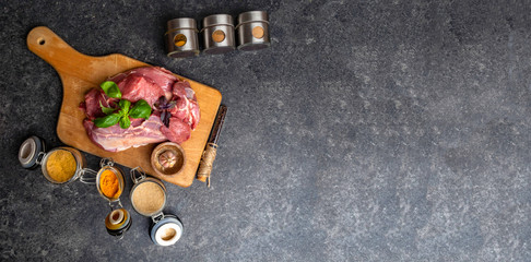 Marinade powder, spices on fresh juicy meat on Gray Background