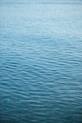 Blue ripple water wave on sand in sea ocean for background