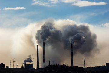 Fototapeta na wymiar The smoke of the Norilsk combine. The sky in the smoke from the chimneys of Norilsk Nickel plant.
