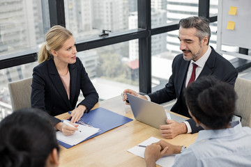 Businessman explaining new business ideas to peers.