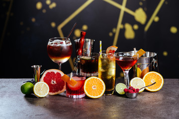 Exotic tasty alcoholic cocktails on dark background