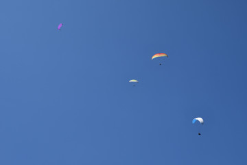 A group of paragliders flying in blue sky, Chamonix-Mont-Blanc, Haute Savoie, France