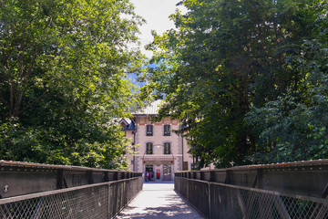 The pedestrian iron bridge that leads to the rack railway station of Chamonix-Mont-Blanc in summer,...