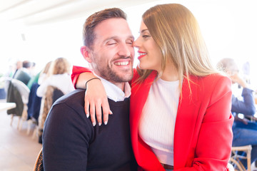 Young beautiful couple in love smiling happy and giving affection to each other