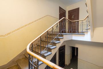 Staircase in the modern light entrance. Doors to apartments.