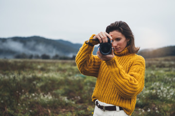 photographer girl take photo on camera closeup on background autumn foggy mountain, tourist shooting nature mist landscape, hobby concept