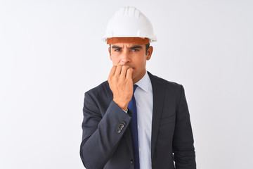 Young handsome architect man wearing suit and helmet over isolated white background looking stressed and nervous with hands on mouth biting nails. Anxiety problem.