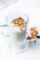 Crispy muesli in a glass with fresh yogurt, morning Breakfast, light snacks. Breakfast cereals isolated on white background, selective focus, top view
