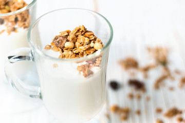 Crispy muesli in a glass with fresh yogurt, morning Breakfast, light snacks. Breakfast cereals isolated on white background, selective focus, top view