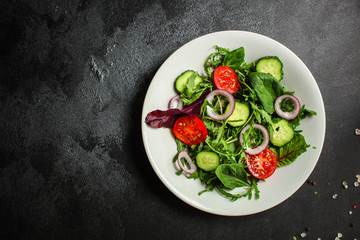 Healthy salad, leaves mix salad (mix micro greens, cucumber, tomato, onion, other ingredients). food background. copy space